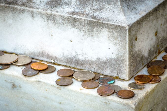 Old Tradition Of Various American Coins Lying On Gravestone As Sign Of Respect