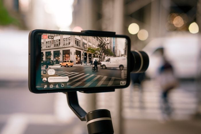 Man doing live video with phone with stabilizer in NY