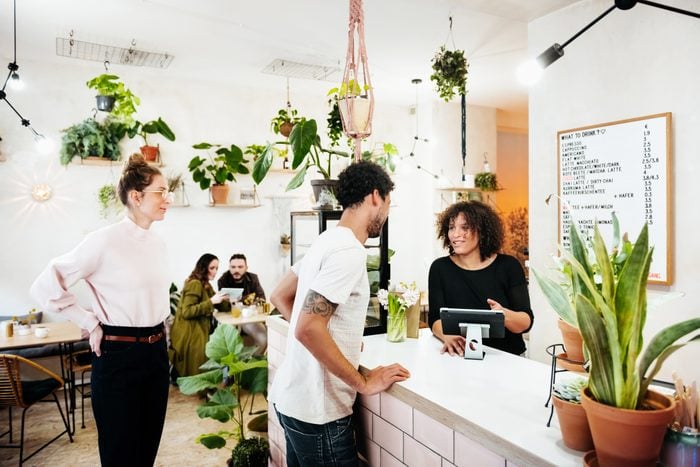 Customers Paying At Café Counter