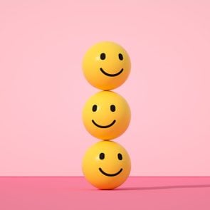 Emoji with smiley face on pink background
