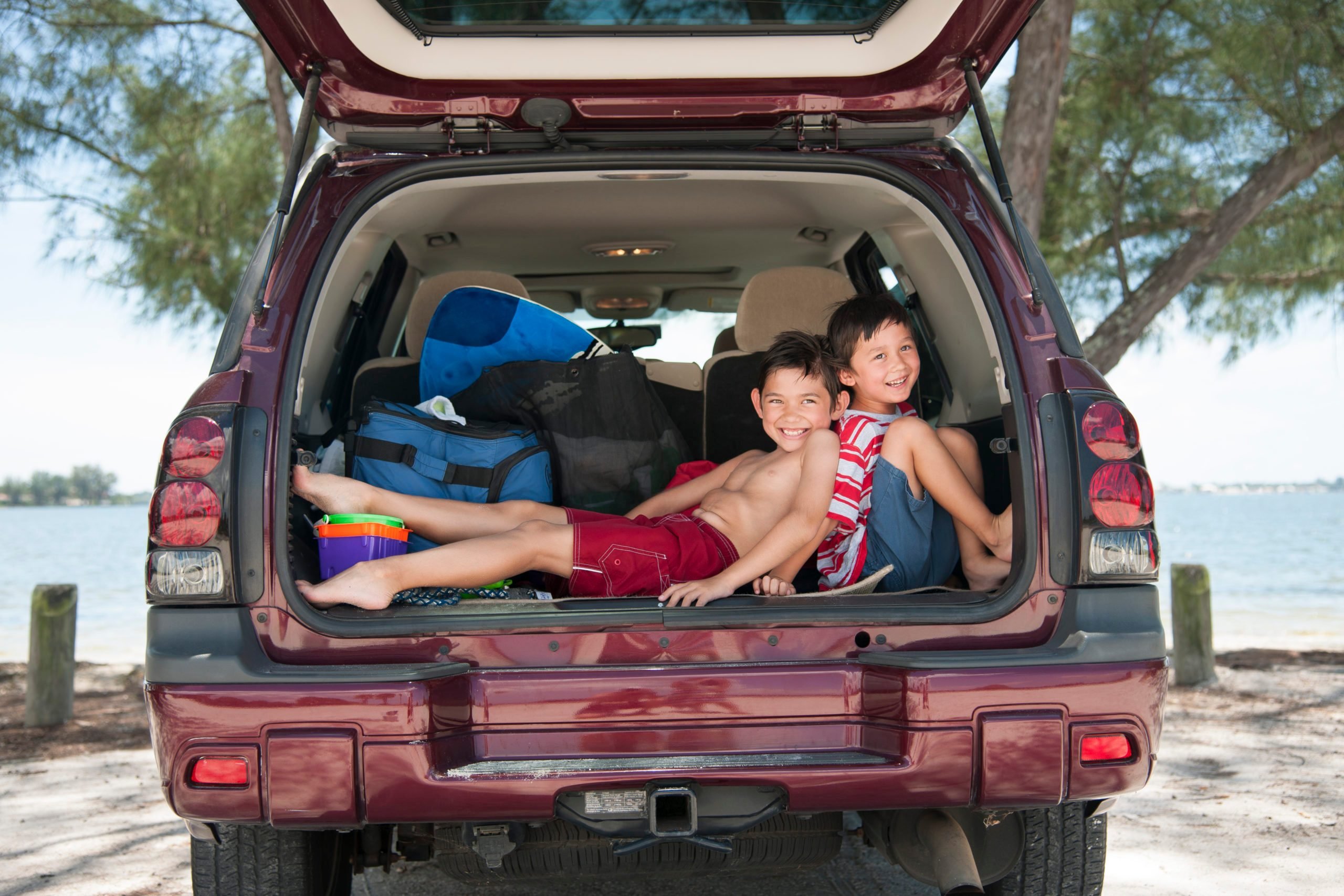 Brothers squishing each other in the car