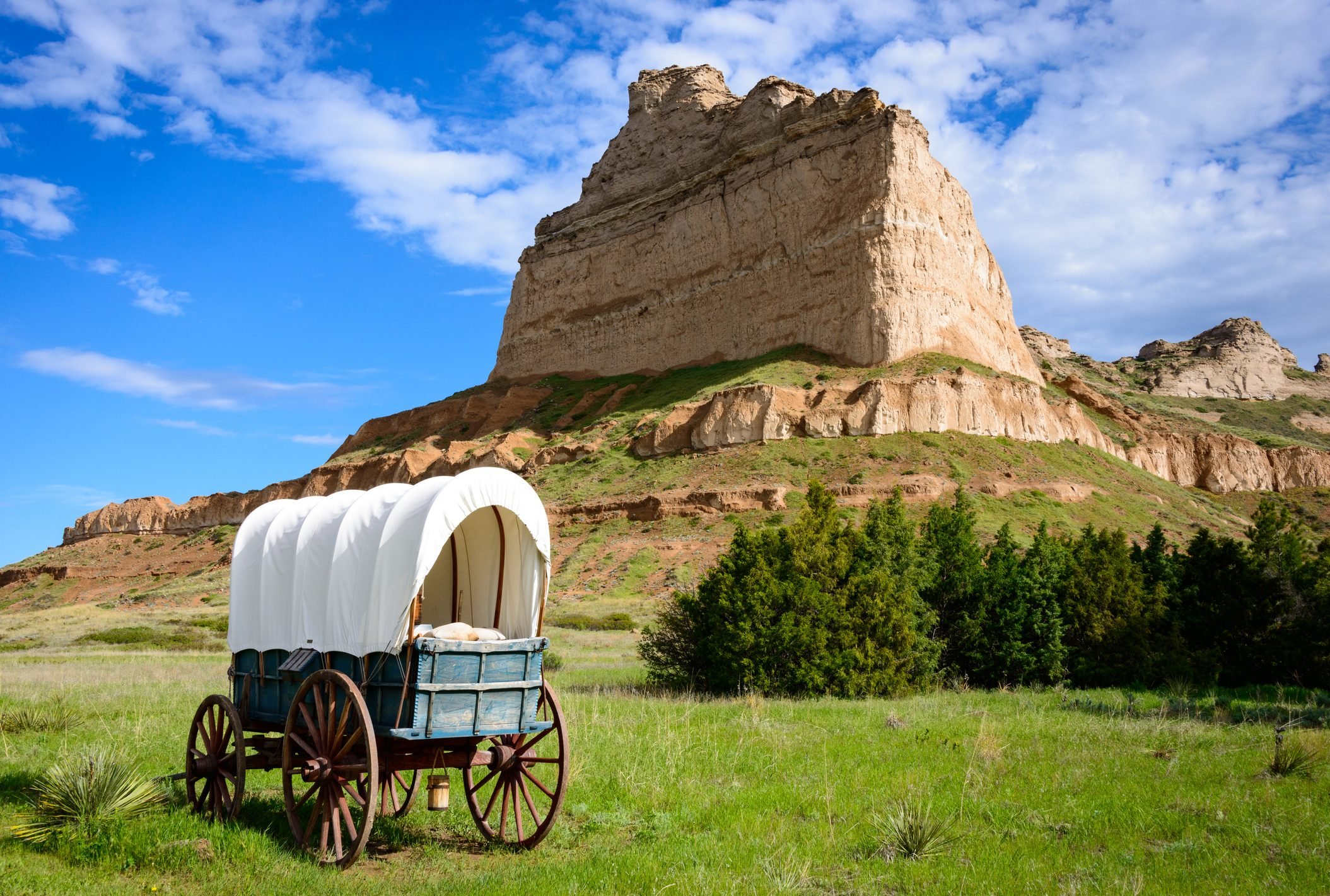 covered wagon in a field at Scotts Bluff National Monument in Nebraska along the Oregon Trail