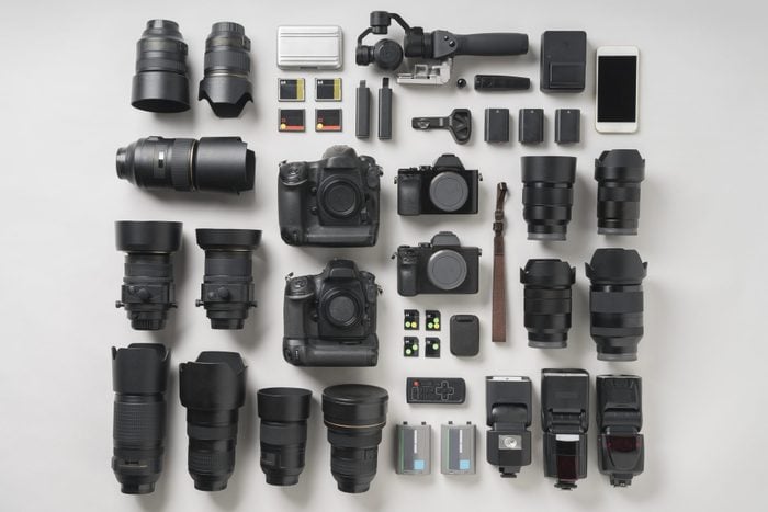 Digital camera item flat lay on gray