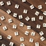 Question mark on alphabet tiles. question mark on wooden table background