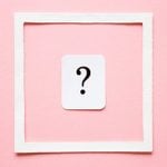 Card of question mark in white frame on pastel pink background. Soft light color. Women issues. Problem and solution concept.